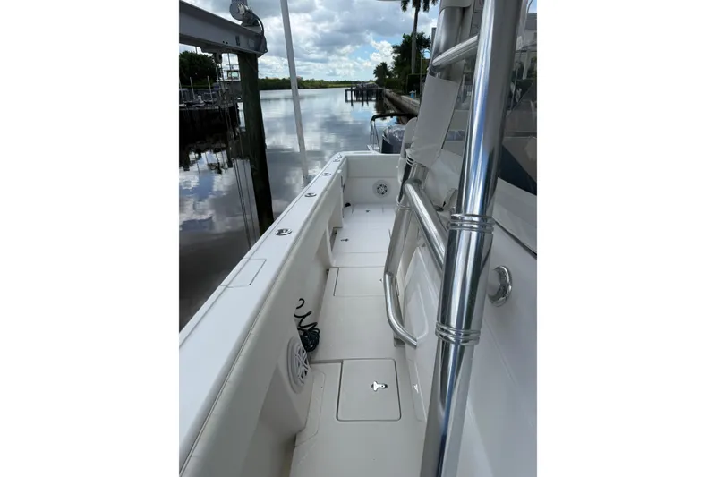 Slide: The Image of 2014 Intrepid 327 Center Console boat docked by a calm river. - 11