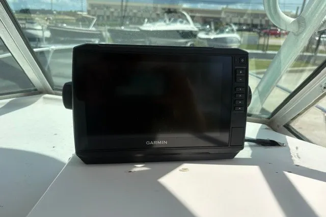 Slide: The Image of Garmin device on 1987 Grady White 22 Sea Farer boat dashboard, with marina background. - 24