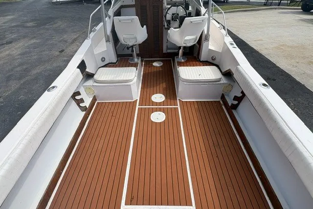 Slide: The Image of 1987 Grady White 22 Sea Farer boat interior with wooden deck and white seating. - 13