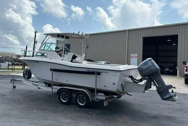 Slide: The Image of 1987 Grady White 22 Sea Farer boat on trailer, parked outside a warehouse. - 6