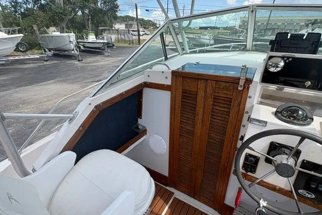Slide: The Image of 1987 Grady White 22 Sea Farer boat interior with steering wheel and wooden accents. - 18
