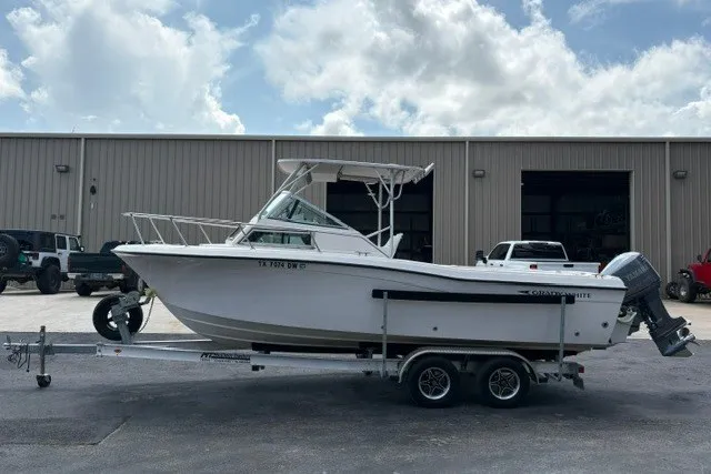 Slide: The Image of 1987 Grady White 22 Sea Farer boat on trailer, parked outside industrial building. - 5