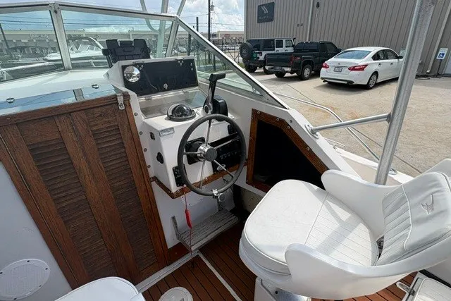 Slide: The Image of 1987 Grady White 22 Sea Farer boat cockpit with steering wheel and seating. - 17
