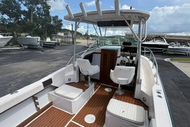 Slide: The Image of 1987 Grady White 22 Sea Farer boat with seating and helm, docked outdoors. - 14
