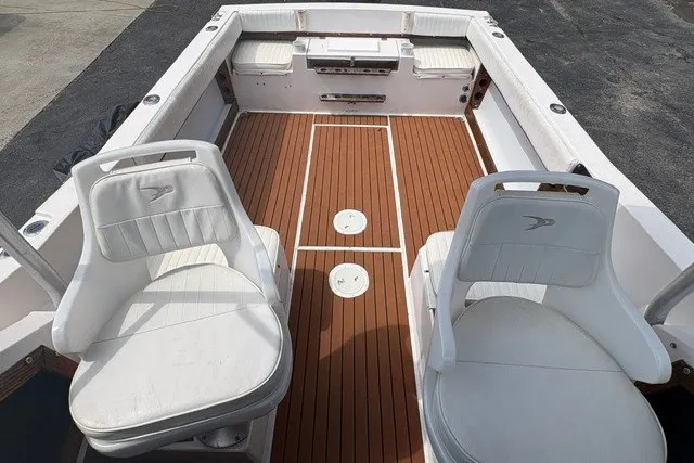 Slide: The Image of 1987 Grady White 22 Sea Farer boat interior with white seats and wooden deck. - 19