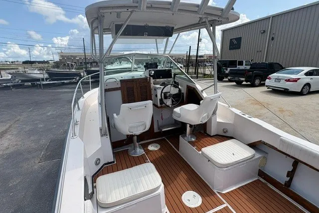 Slide: The Image of 1987 Grady White 22 Sea Farer boat with spacious deck and seating, parked outdoors. - 15