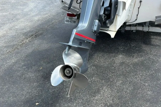 Slide: The Image of 1987 Grady White 22 Sea Farer boat motor and propeller on asphalt surface. - 9