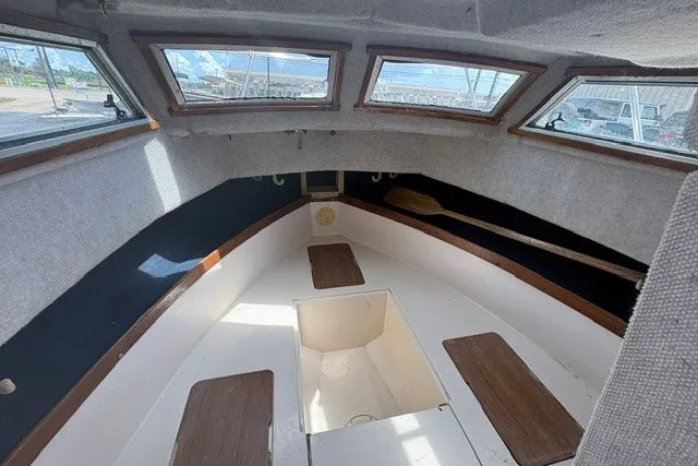 Slide: The Image of Interior of a 1987 Grady White 22 Sea Farer boat with windows and storage compartments. - 22