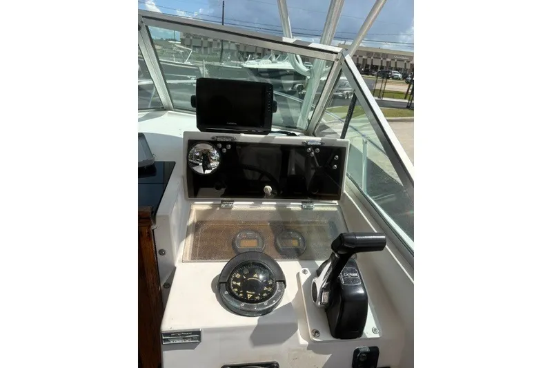 Slide: The Image of 1987 Grady White 22 Sea Farer boat dashboard with navigation instruments and controls. - 25