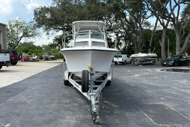 Slide: The Image of 1987 Grady White 22 Sea Farer boat on trailer, parked outdoors with trees in background. - 28