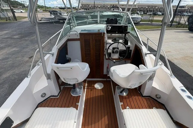 Slide: The Image of 1987 Grady White 22 Sea Farer boat interior with dual seats and wooden flooring. - 16