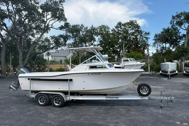 The Image of 1987 Grady White 22 Sea Farer boat on trailer, parked outdoors under clear sky. - 1