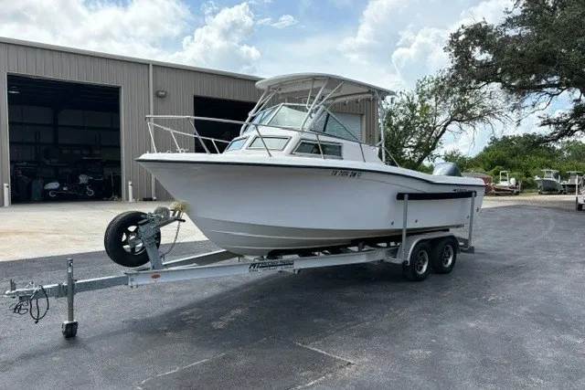 Slide: The Image of 1987 Grady White 22 Sea Farer boat on trailer, parked outside a warehouse. - 29
