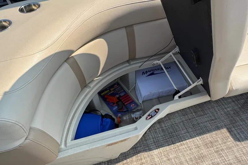 Slide: The Image of Storage compartment in a 2020 Harris Cruiser 210 boat with various boating accessories. - 12
