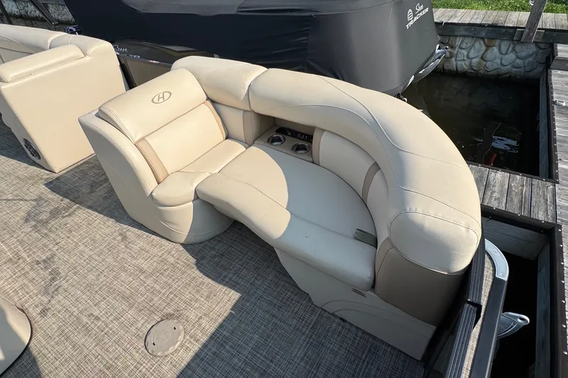 Slide: The Image of 2020 Harris Cruiser 210 boat with beige seating and cup holders on deck. - 4