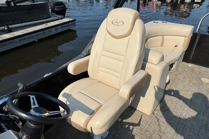 Slide: The Image of Captain's chair on 2020 Harris Cruiser 210 pontoon boat, docked by the water. - 28