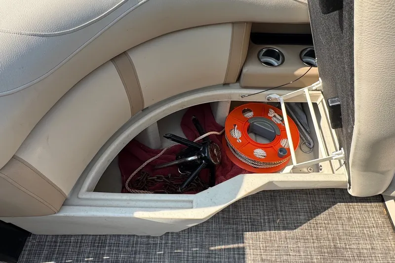 Slide: The Image of A storage compartment in a boat with an anchor and an orange rope. - 8