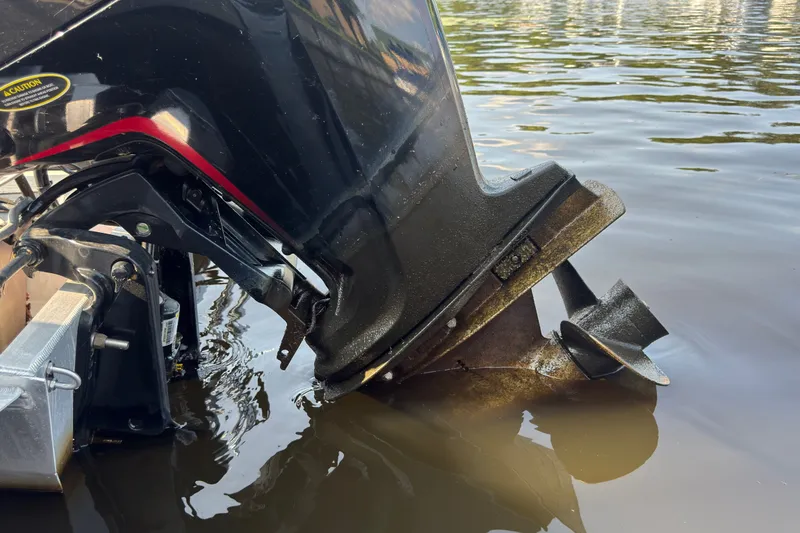 Slide: The Image of Outboard motor of a 2020 Harris Cruiser 210 partially submerged in water. - 16
