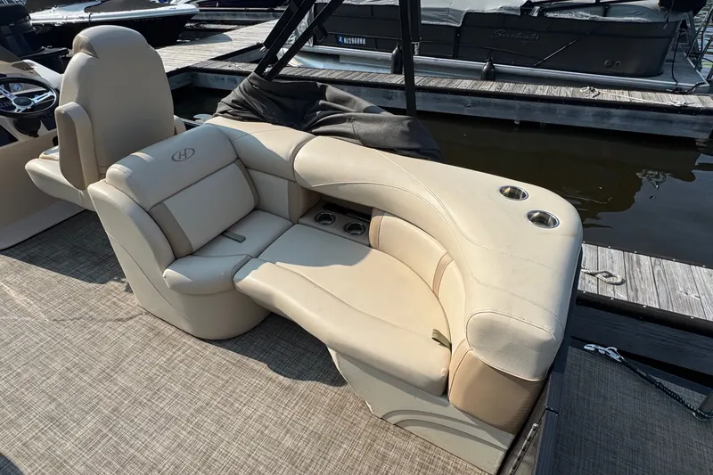 Slide: The Image of Luxurious seating on a 2020 Harris Cruiser 210 pontoon boat at a marina dock. - 5