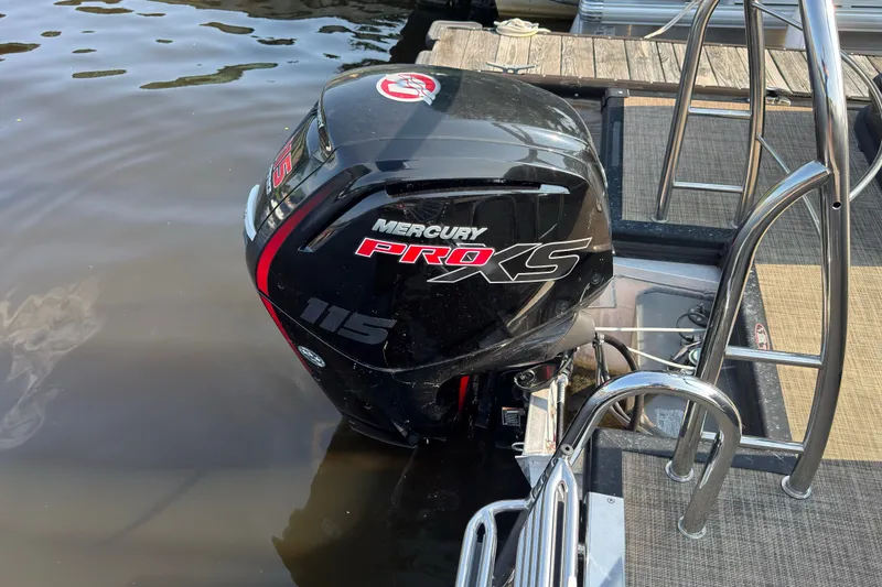 Slide: The Image of Outboard motor on 2020 Harris Cruiser 210 pontoon boat docked by water. - 15