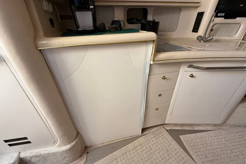 Slide: The Image of Interior view of a 2000 Sea Ray 340 Sundancer kitchen area with cabinets and countertop. - 23