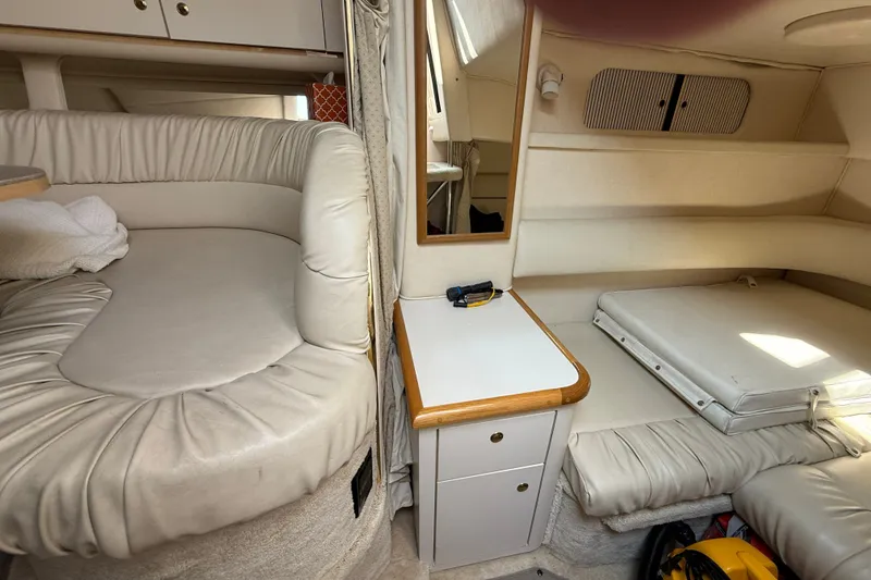 Slide: The Image of Interior of a 2000 Sea Ray 340 Sundancer boat with cushioned seating and storage. - 18