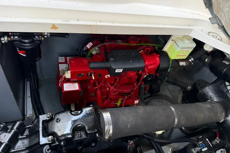 Slide: The Image of Engine compartment of a 2000 Sea Ray 340 Sundancer, featuring a red engine. - 28
