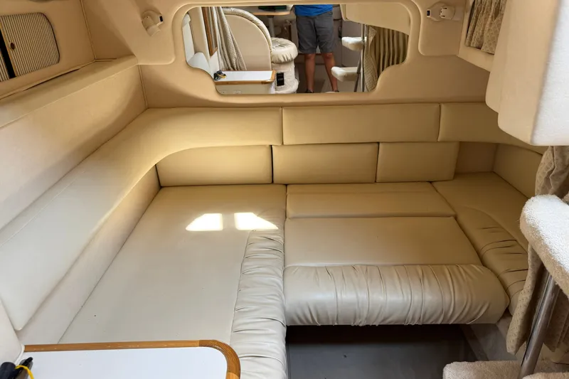 Slide: The Image of Interior cabin of a 2000 Sea Ray 340 Sundancer with beige seating and cozy layout. - 22