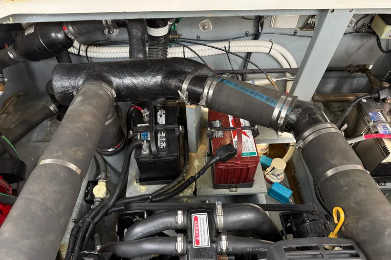 Slide: The Image of Engine compartment of a 2000 Sea Ray 340 Sundancer with visible marine wiring and components. - 27