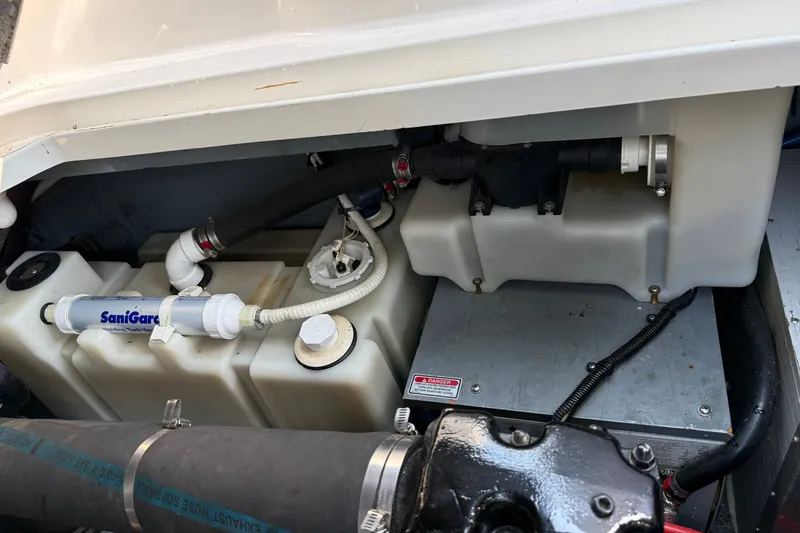 Slide: The Image of Engine compartment of a 2000 Sea Ray 340 Sundancer with visible plumbing and components. - 26