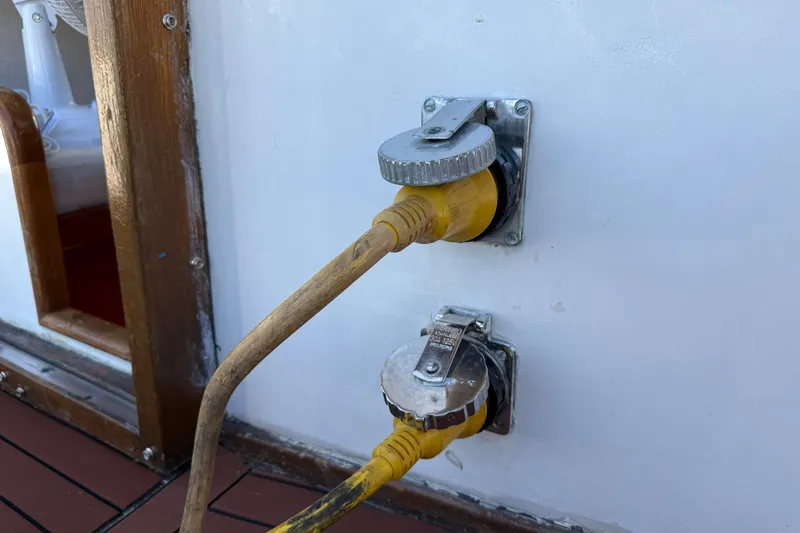 Slide: The Image of Power connections on 1982 Albin 36 Trawler boat, featuring yellow cables and metal sockets. - 13