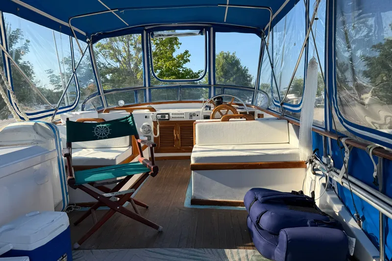 Slide: The Image of Interior of 1982 Albin 36 Trawler with blue canopy and wooden accents. - 14