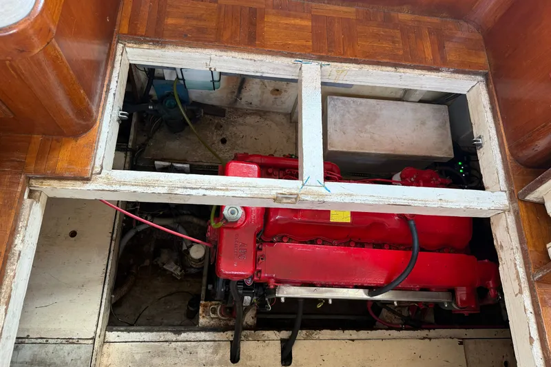 Slide: The Image of Engine compartment of a 1982 Albin 36 Trawler with visible red engine. - 33