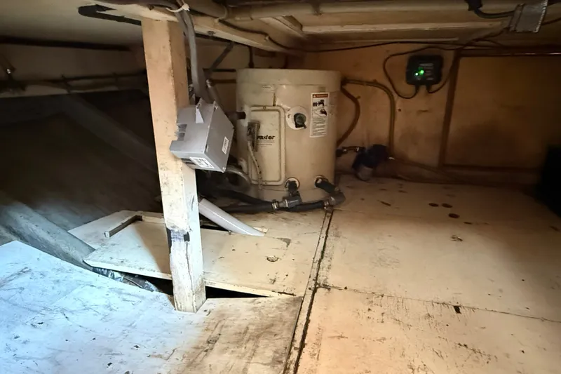 Slide: The Image of Bilge area of 1982 Albin 36 Trawler with water heater and electrical components. - 35