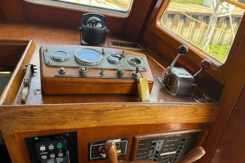 Slide: The Image of Wooden helm of 1982 Albin 36 Trawler with gauges and controls. - 23