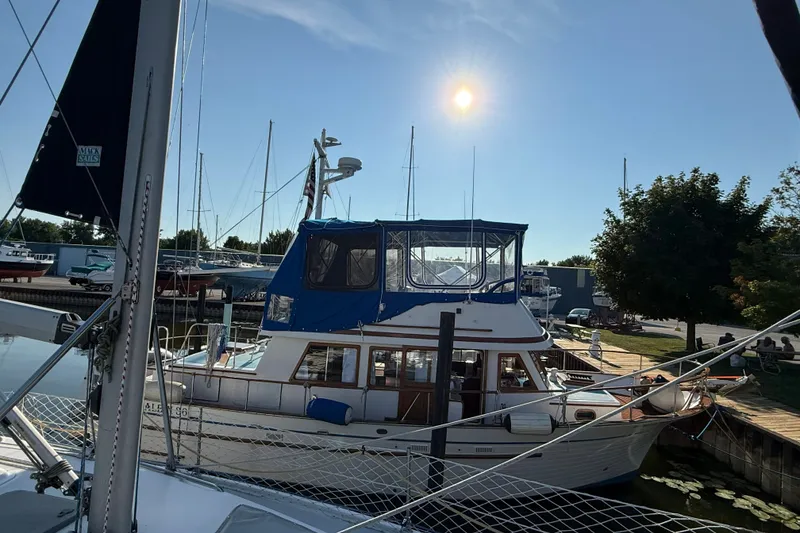 Slide: The Image of 1982 Albin 36 Trawler docked under a clear blue sky with sun shining. - 1