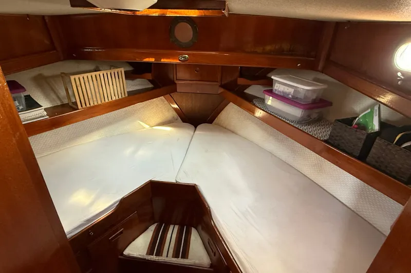Slide: The Image of Cozy cabin interior of 1982 Albin 36 Trawler with wooden finish and storage. - 20