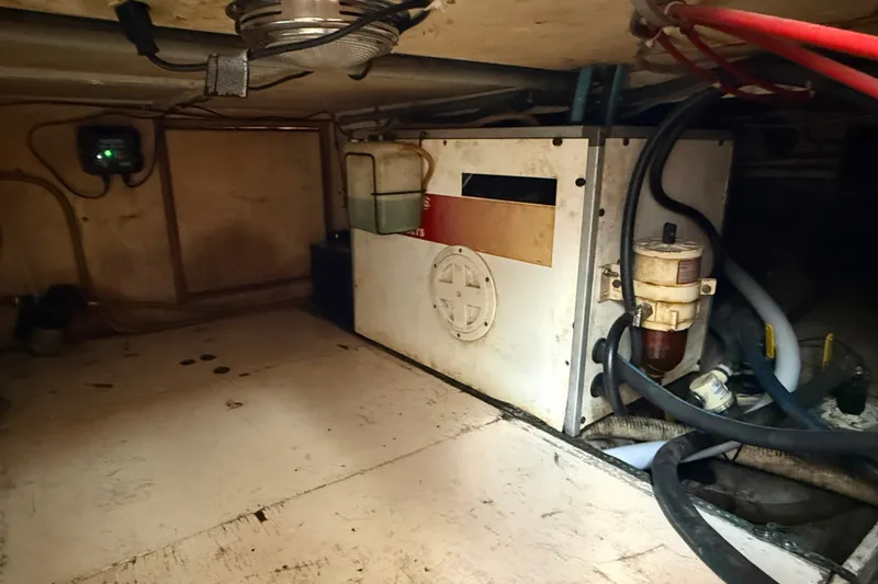 Slide: The Image of Engine room of 1982 Albin 36 Trawler with visible machinery and wiring. - 36