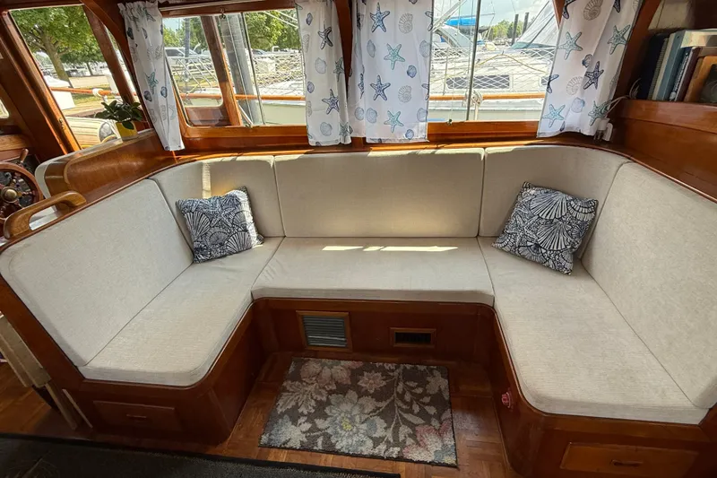Slide: The Image of Interior of 1982 Albin 36 Trawler with cozy seating and nautical-themed decor. - 26