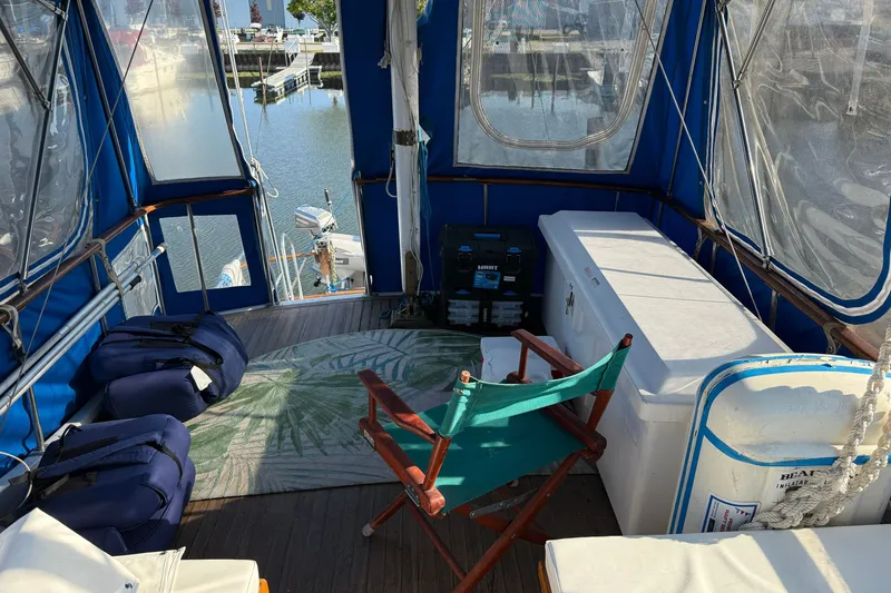 Slide: The Image of Interior view of a 1982 Albin 36 Trawler with seating and storage, docked at a marina. - 15