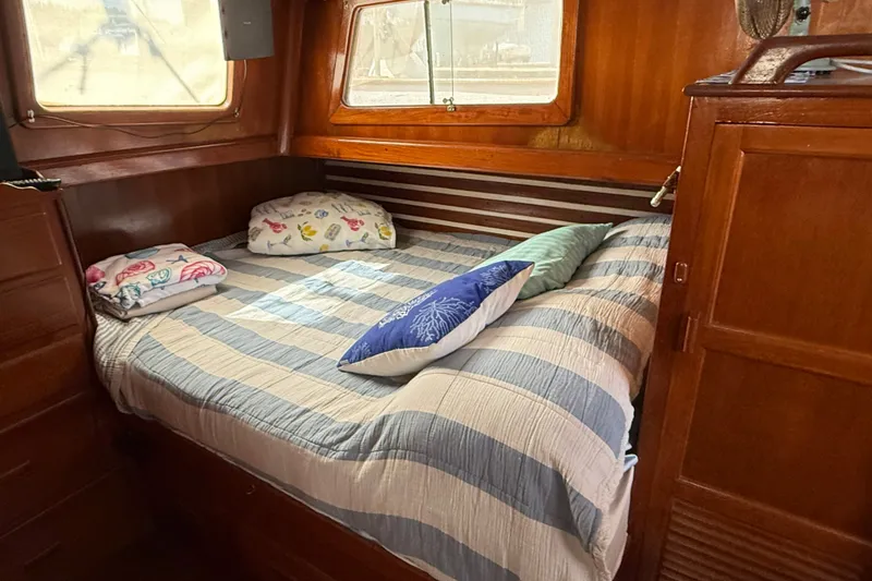 Slide: The Image of Cozy cabin interior of 1982 Albin 36 Trawler with striped bedding and wooden furnishings. - 28