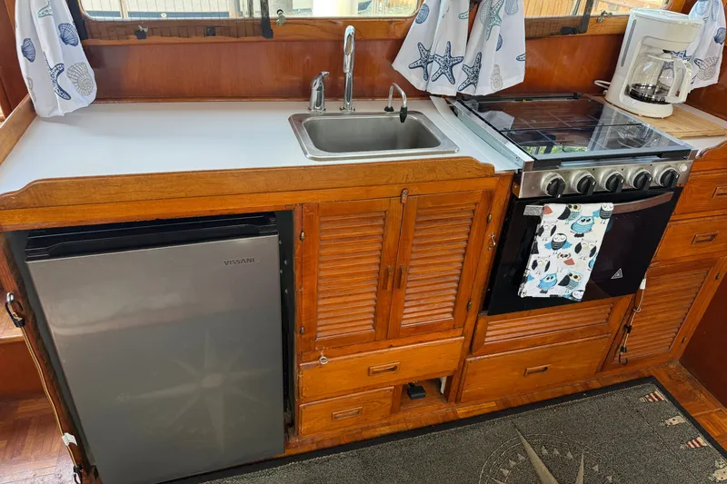 Slide: The Image of Galley kitchen in 1982 Albin 36 Trawler with sink, stove, and fridge. - 25