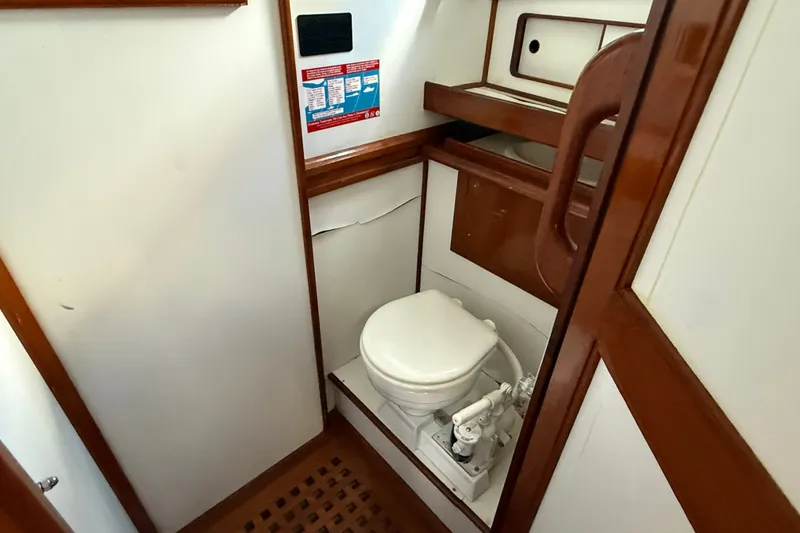 Slide: The Image of 1982 Albin 36 Trawler bathroom with wooden accents and compact marine toilet. - 21