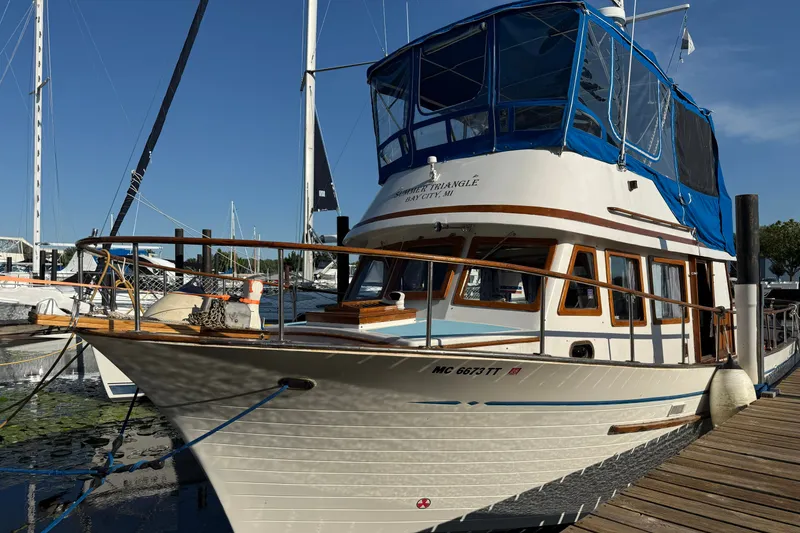 The Image of 1982 Albin 36 Trawler docked at marina under clear blue sky. - 0