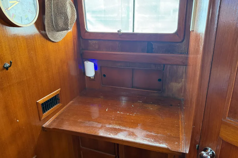 Slide: The Image of Wooden interior of 1982 Albin 36 Trawler with desk, window, and hat. - 29