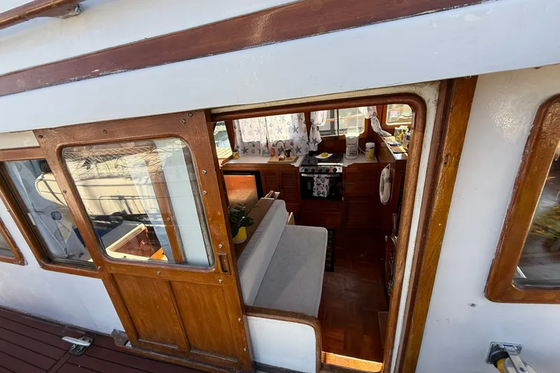 Slide: The Image of Interior view of 1982 Albin 36 Trawler, showcasing cozy cabin and wooden details. - 6