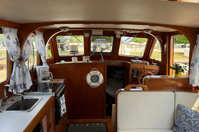 Slide: The Image of Interior of 1982 Albin 36 Trawler with cozy seating, kitchenette, and nautical decor. - 24
