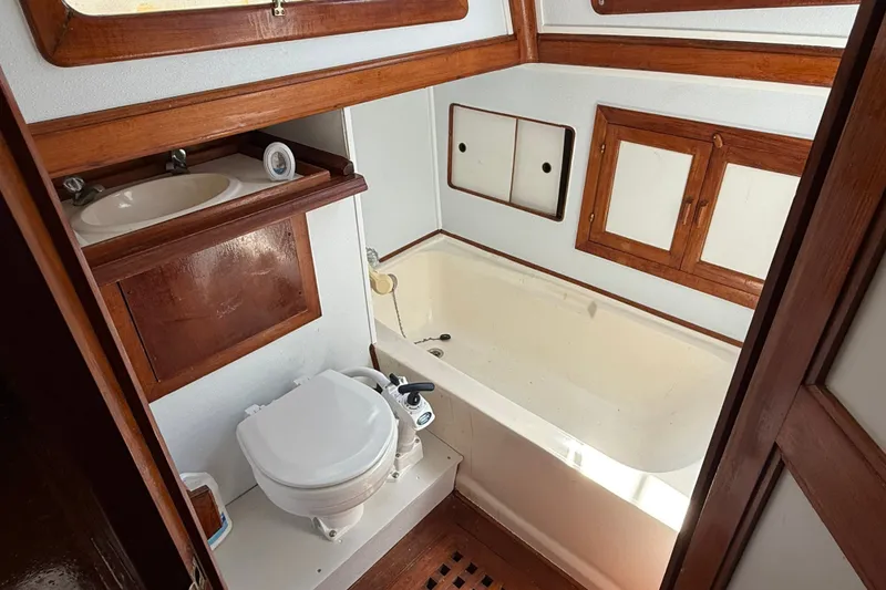 Slide: The Image of Bathroom interior of 1982 Albin 36 Trawler with wooden accents and compact design. - 30