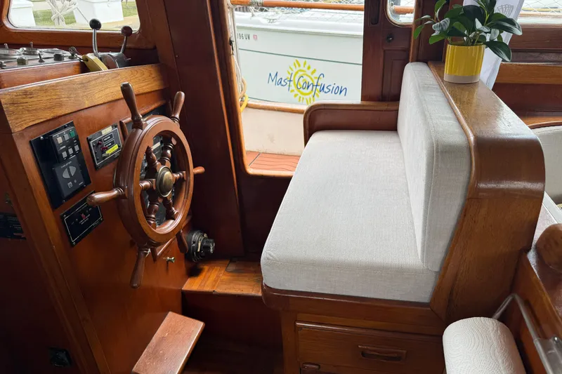 Slide: The Image of Interior of 1982 Albin 36 Trawler with wooden helm and cushioned seating. - 22