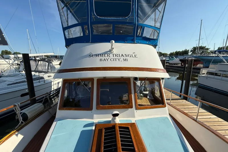 Slide: The Image of 1982 Albin 36 Trawler docked, named "Summer Triangle," in Bay City marina. - 4